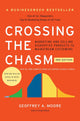 Book cover of 'Crossing the Chasm' with an orange background and colorful diagram.
